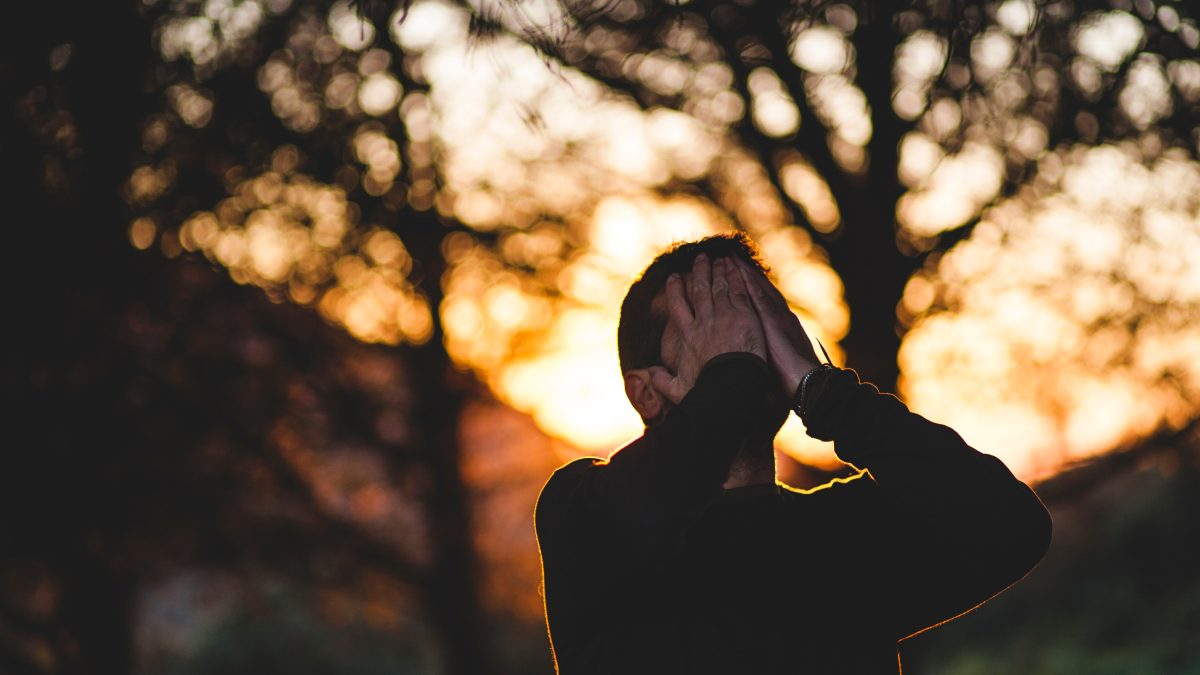 Man gives self Reiki in nature after a Reiki Healing at Radiant You